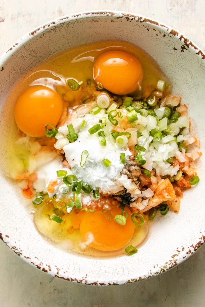 Picture shows all the ingredients added to a white mixing bowl