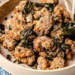 Taiwanese popcorn chicken recipe - yan su ji - with super crunchy coating and fried basil leaves served in a light pink plate.