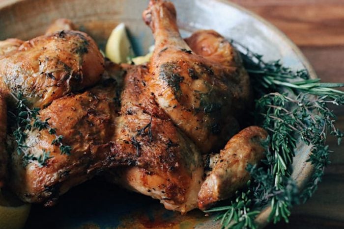 Simple Herb Roasted Spatchcock Chicken with rosemary, thyme, lemon, and garlic for Paleo Whole30 Keto holiday recipe.