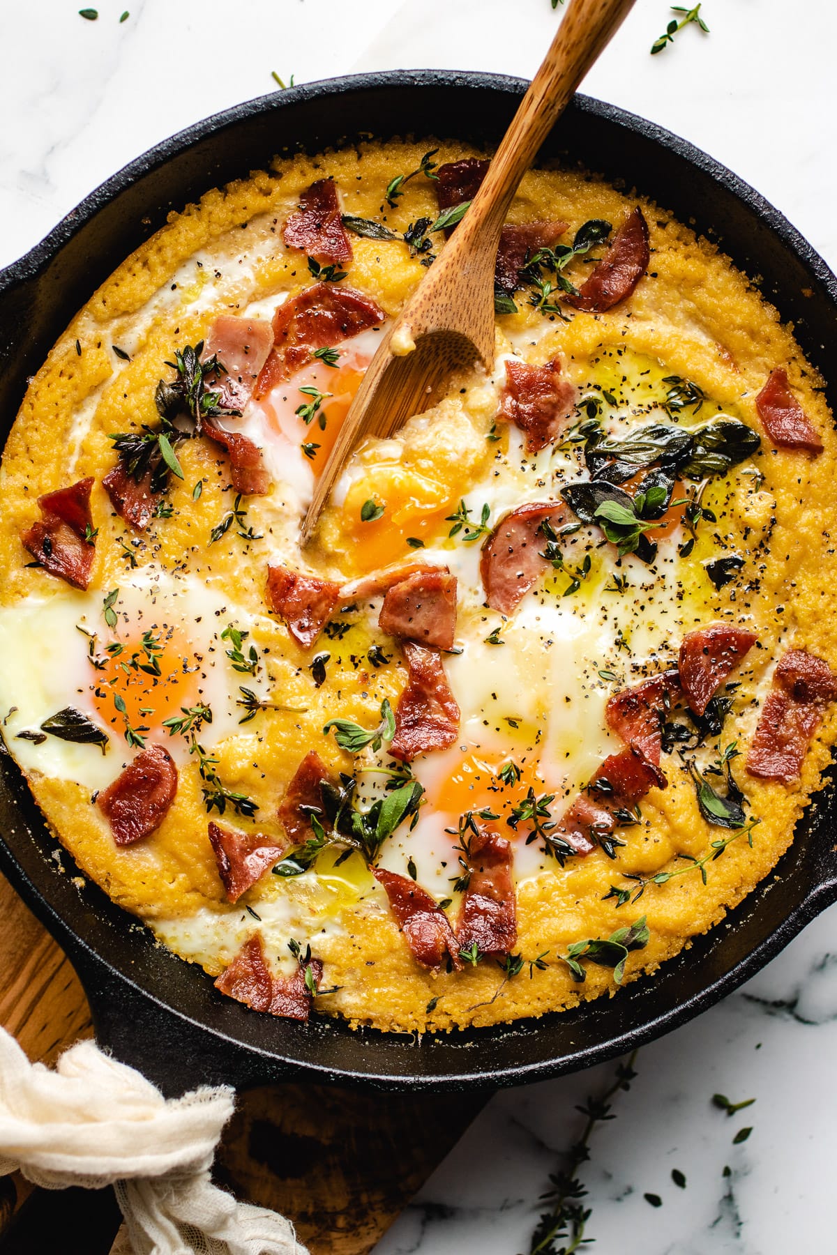 grits with creamy egg yolks served in a cast iron skillet