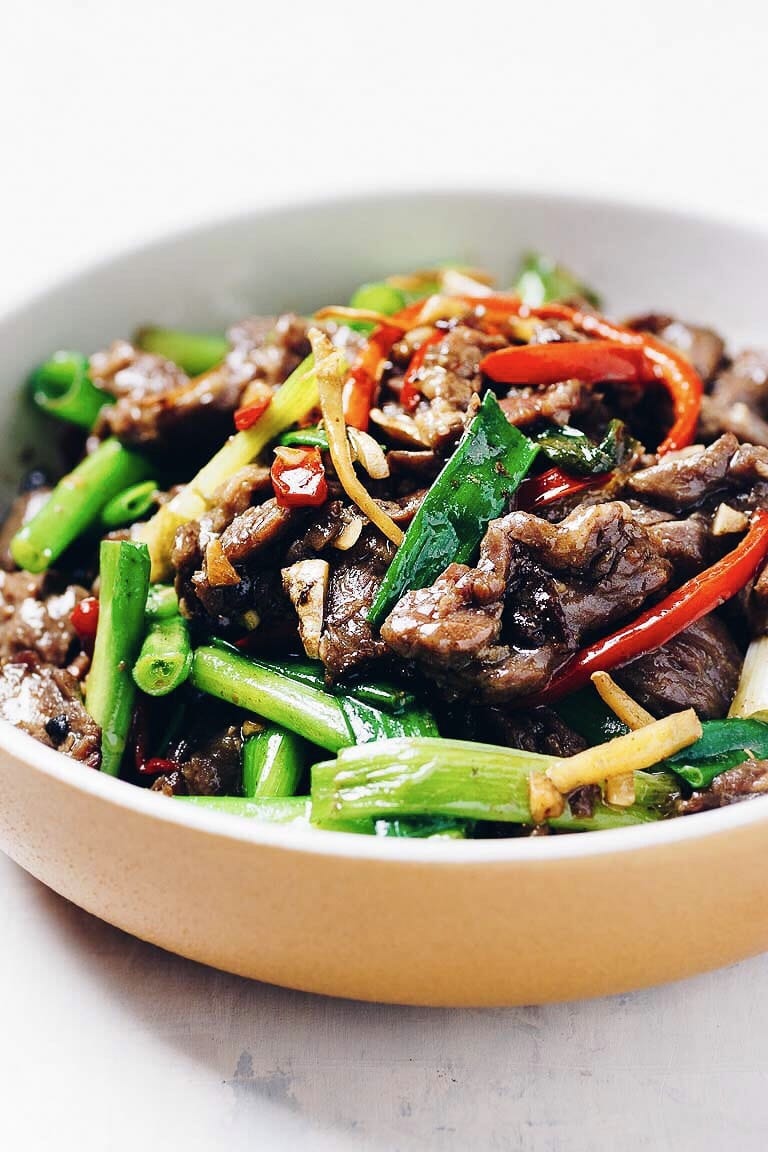 Stir-Fried Chinese Beef Mongolian style with big onions, chili peppers and ginger served in a round shape bowl