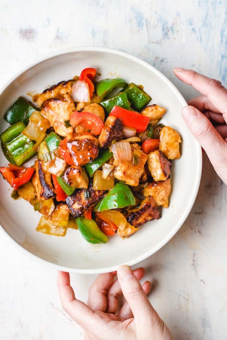 Chinese sweet and sour chicken recipe served in a big white plate.