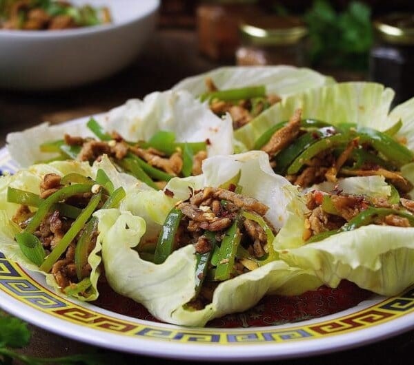 Paleo Chinese Spicy Pepper Pork Lettuce Wraps. Thin sliced pepper pork wrapped in iced crunchy lettuce wraps in Chinese spicy chili sauce. Paleo Chinese food. Paleo Asian food. IHeartUmami.com