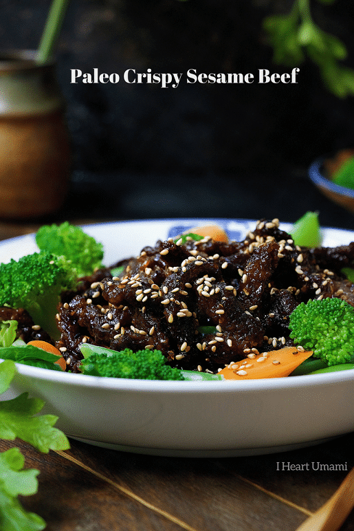 Paleo crispy sesame beef ! Thin sliced sirloin steak pan fried to golden crispy paired with light refreshing veggies. Healthy and super-delicious sesame beef that won't weigh you down. Paleo Chinese takeout. IHeartUmami.com