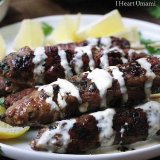 Delicious Paleo lamb kebab skewers recipe with fresh herbs in dairy free Tzatziki inspired tahini dressing.