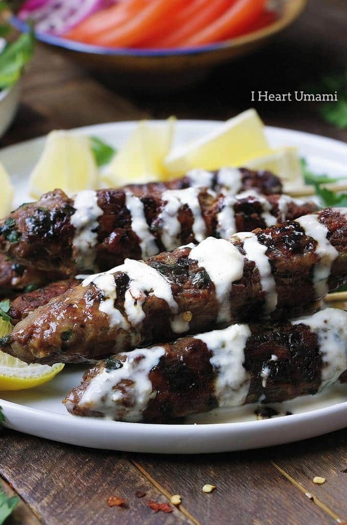 Delicious Paleo lamb kebab skewers recipe with fresh herbs in dairy free Tzatziki inspired tahini dressing.