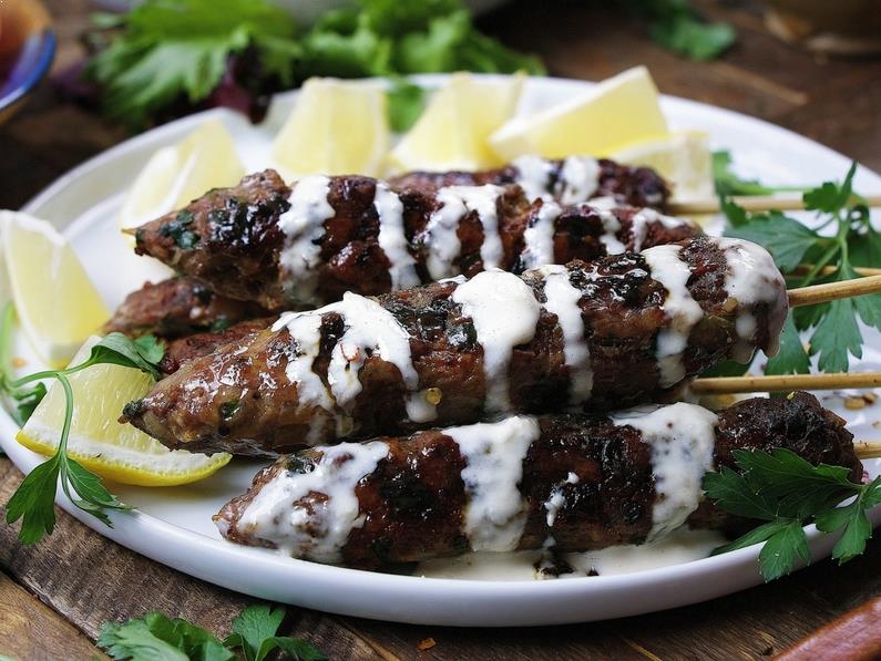 Delicious Paleo lamb kebab skewers recipe with fresh herbs in dairy free Tzatziki inspired tahini dressing.