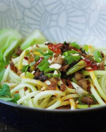 Easy and low carb Paleo Dan Dan Zucchini Noodles recipe with crispy crumble pork and bok choy vegetable in creamy sesame noodle dressing.
