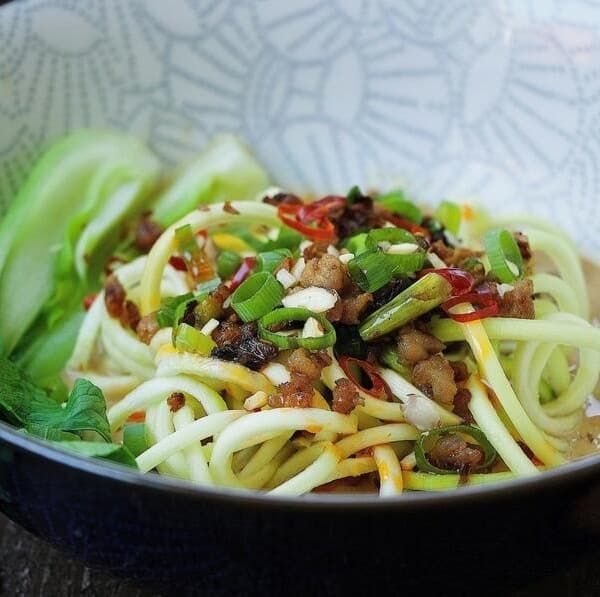 Easy and low carb Paleo Dan Dan Zucchini Noodles recipe with crispy crumble pork and bok choy vegetable in creamy sesame noodle dressing.