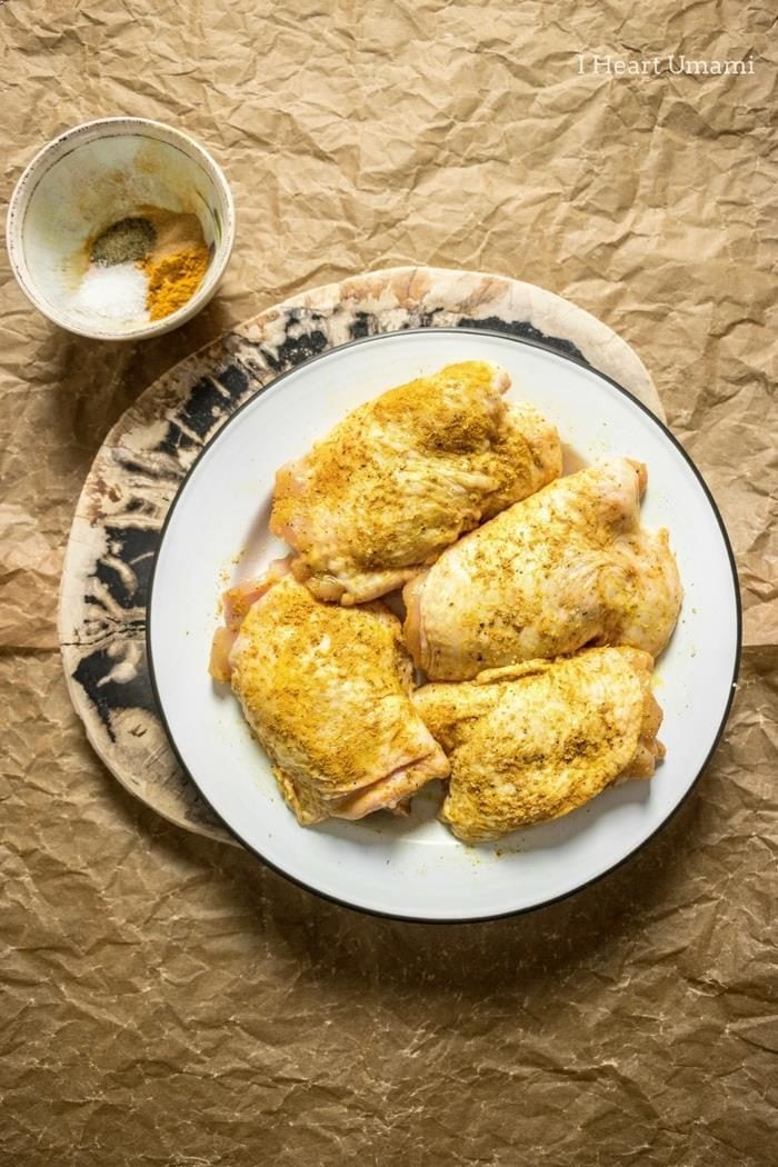 A super simple and truly delicious Oven Baked Crispy Tender Turmeric Chicken Thighs recipe with crispy skins and tender juicy thigh meat baked in turmeric coconut milk cream until sweet and melt-in-your mouth creamy juicy. This simple flavorful and little hands-on time dish will become your everyday go-to chicken thigh casserole recipe ! #bakedchickenthighs #chickenthighs #ovenbaked #chicken #chickencasserole #iheartumami