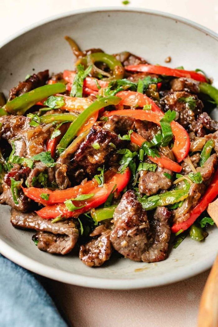 A side close shot shows pepper steak chinese style served on a white color plate