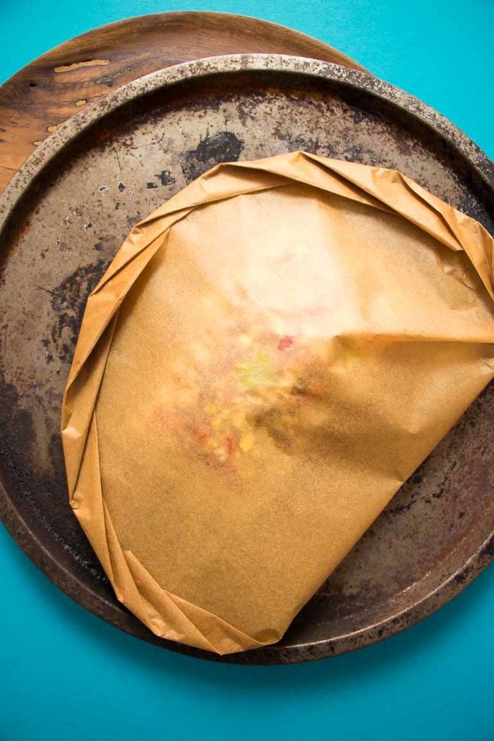 Paleo Fish en Papillote recipe, wrapped in parchment paper with Thai lemongrass and crispy garlic cloves.