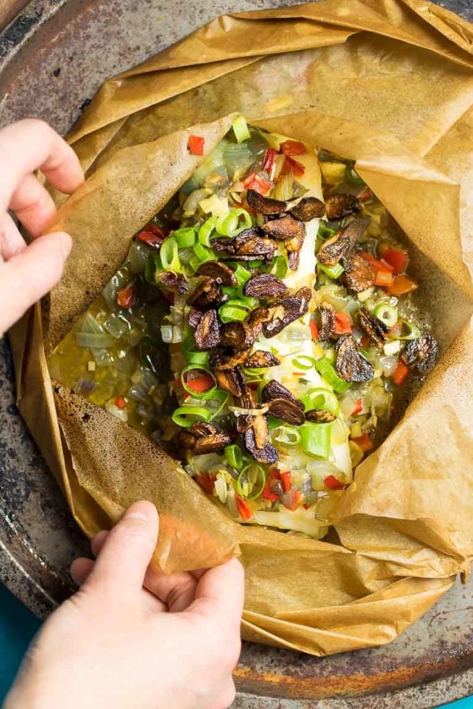 Paleo Fish en Papillote recipe, wrapped in parchment paper with Thai lemongrass and crispy garlic cloves.