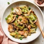 A recipe shows chicken breasts stir fried with cabbage and shiitake served on a white plate