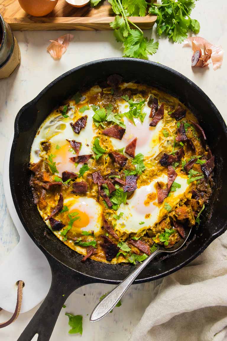 Healthy Shakshuka Recipe with meat and eggs in tomato sauce.