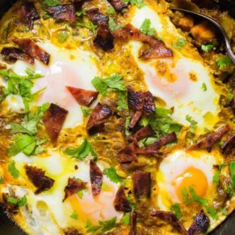 Healthy Shakshuka Recipe with meat and eggs in tomato sauce.