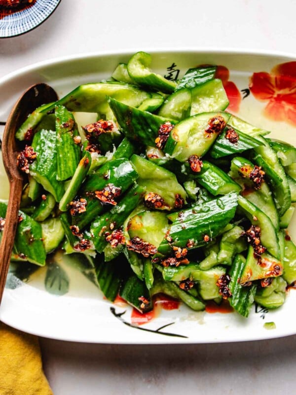 Smashed Chinese cucumber salad served on a white plate.