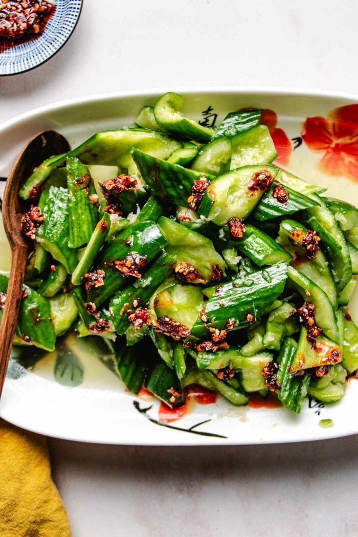 Smashed Chinese cucumber salad served on a white plate.