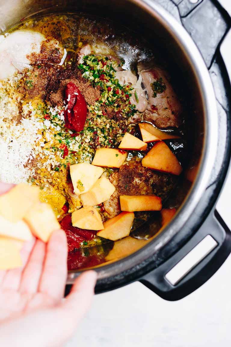 Photo shows adding cubed pumpkin to the instant pot