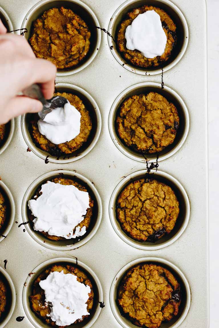 Paleo Pumpkin Protein Muffins Recipe with dark chocolate and coconut yogurt frosting.