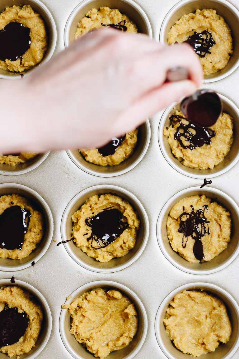 Paleo Pumpkin Protein Muffins Recipe with dark chocolate and coconut yogurt frosting.