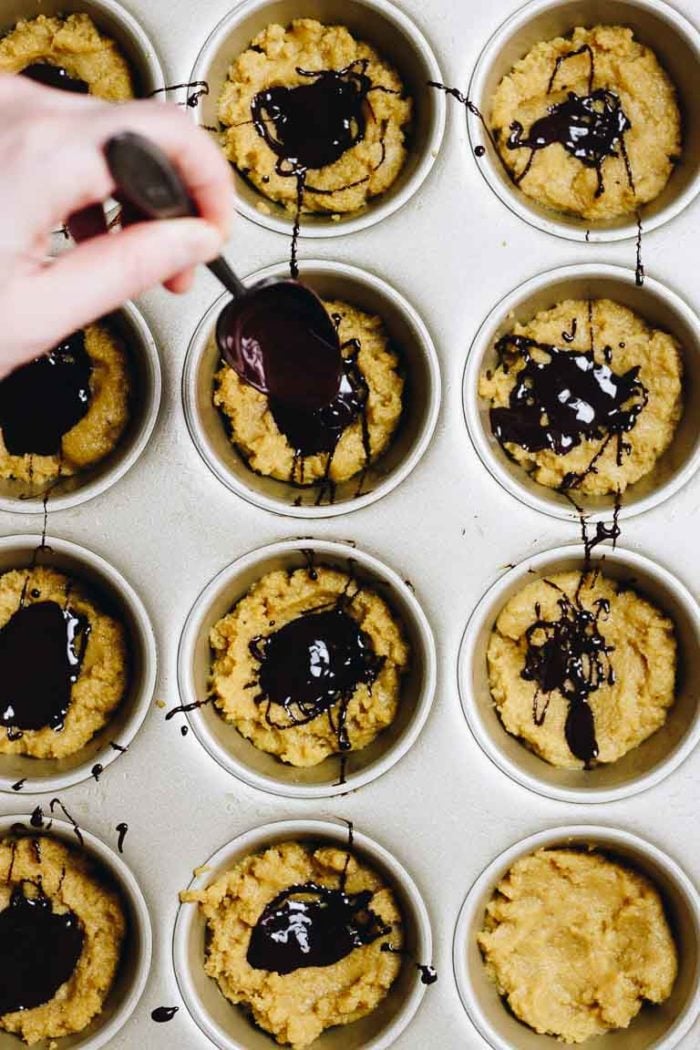 Paleo Pumpkin Protein Muffins Recipe with dark chocolate and coconut yogurt frosting.