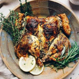 Simple Herb Roasted Spatchcock Chicken with rosemary, thyme, lemon, and garlic for Paleo Whole30 Keto holiday recipe.