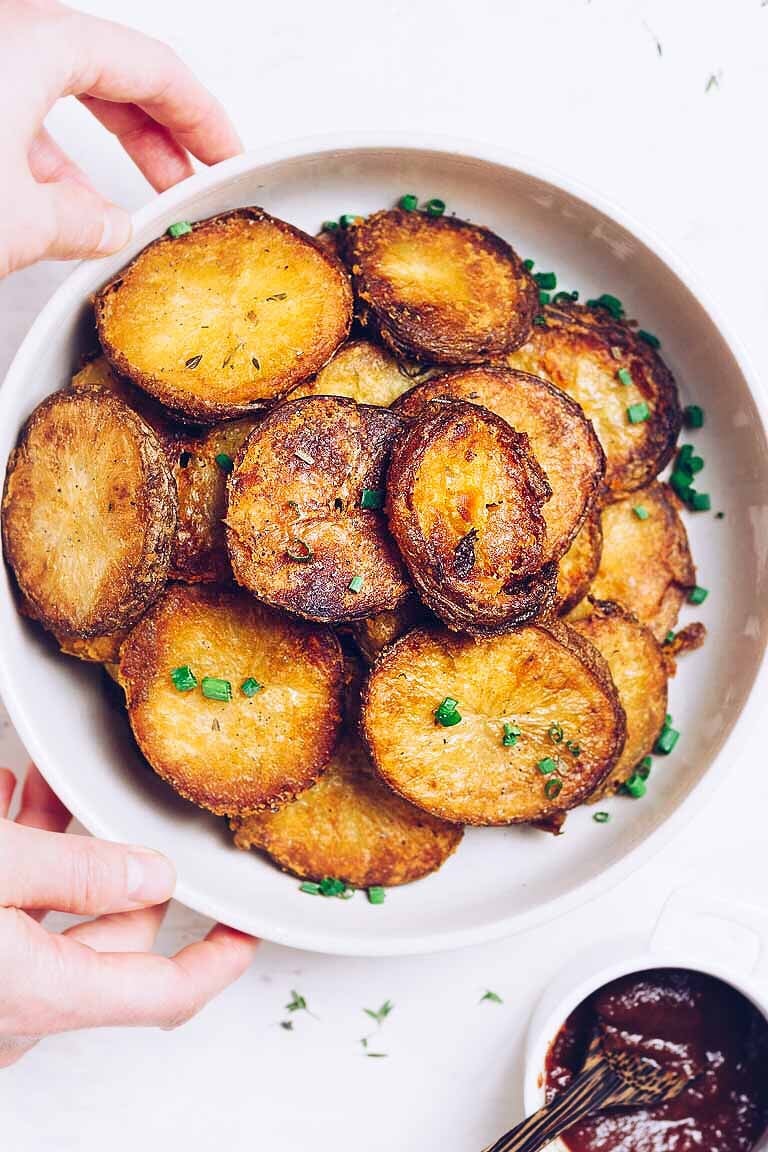 Whole30 Oven Roasted Crispy Potatoes recipe with rosemary and thyme infused oil.