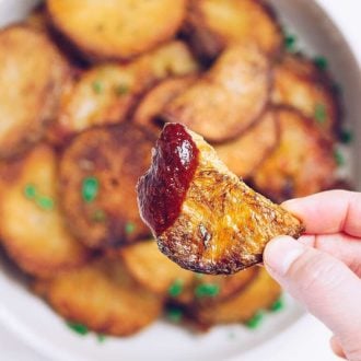 Whole30 Oven Roasted Crispy Potatoes recipe with rosemary and thyme infused oil.