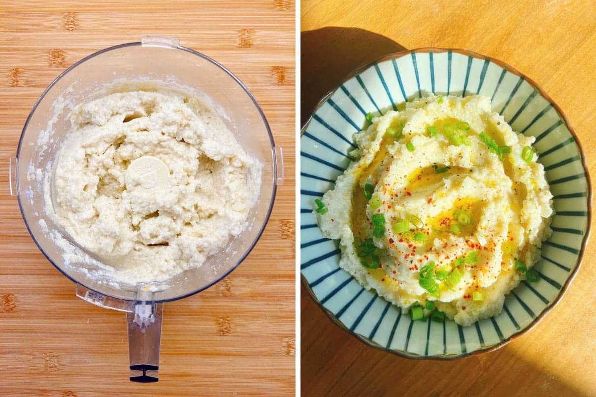 A food processor with creamy low carb cauliflower mashed potatoes on the left, and a bowl of garnished cauliflower mashed potatoes topped with green onions, seasoning, and oil on the right, both on a wooden surface.