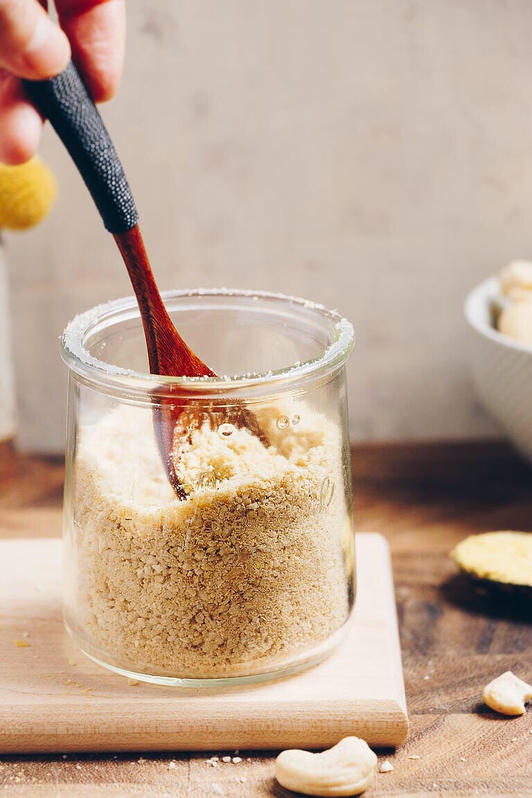 Dairy-Free Paleo Parmesan Cheese made with cashew and nutritional yeast for non dairy substitute parmesan cheese.