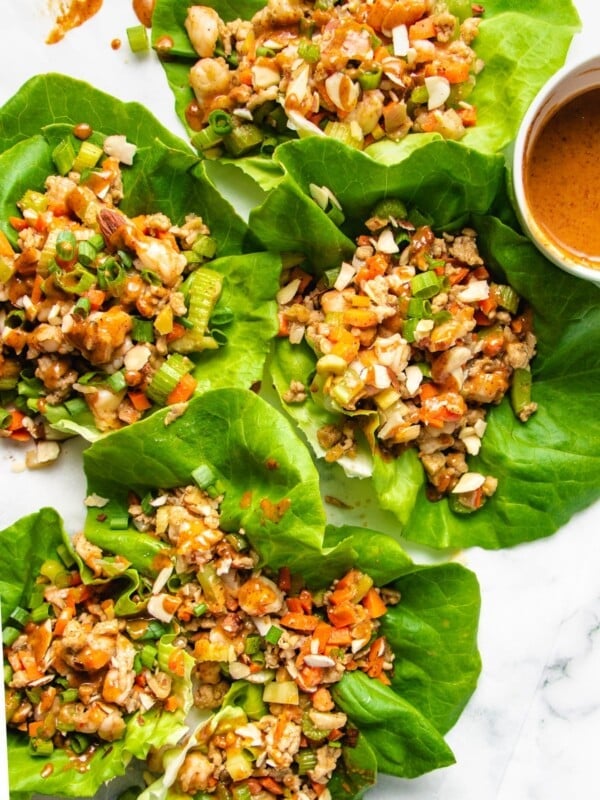 Photo displays lettuce wraps over a white canvas plate