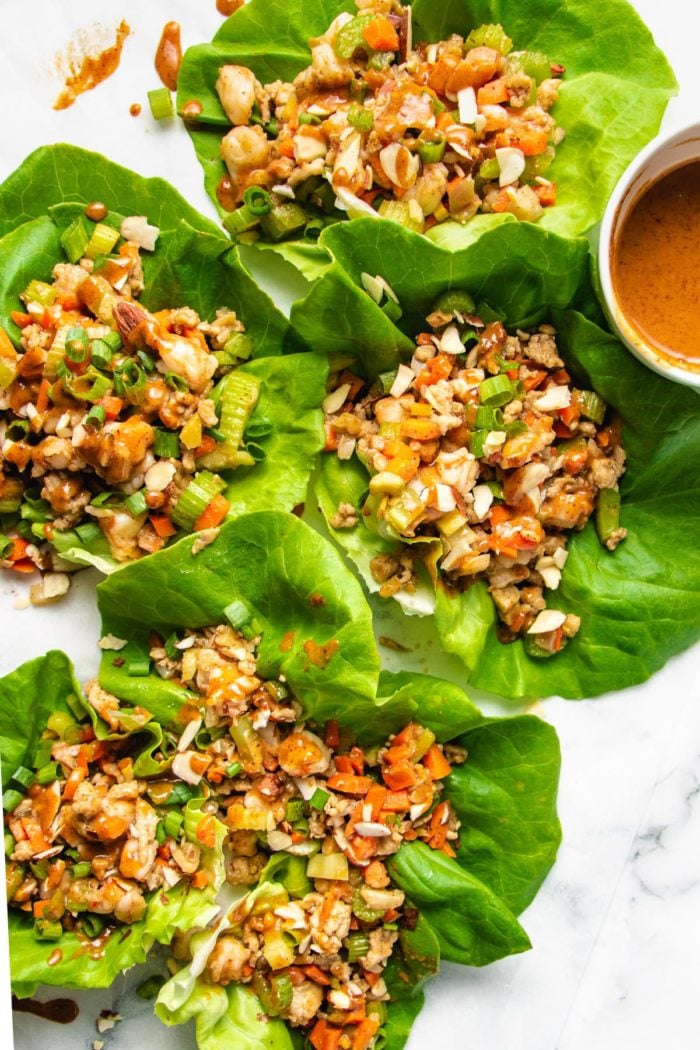 Photo displays lettuce wraps over a white canvas plate