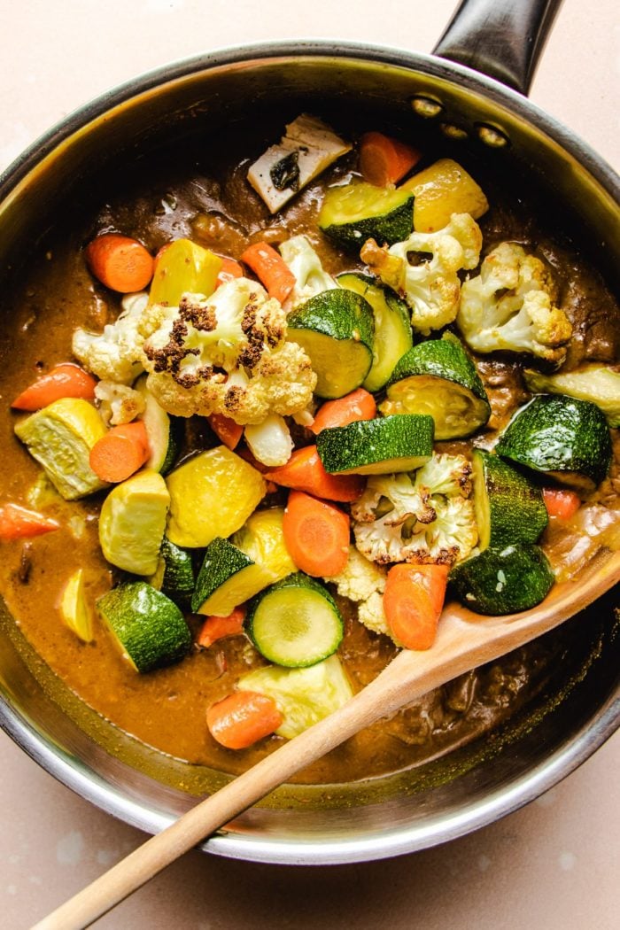 Photo shows a big skillet with curry sauce and roasted vegetables on top