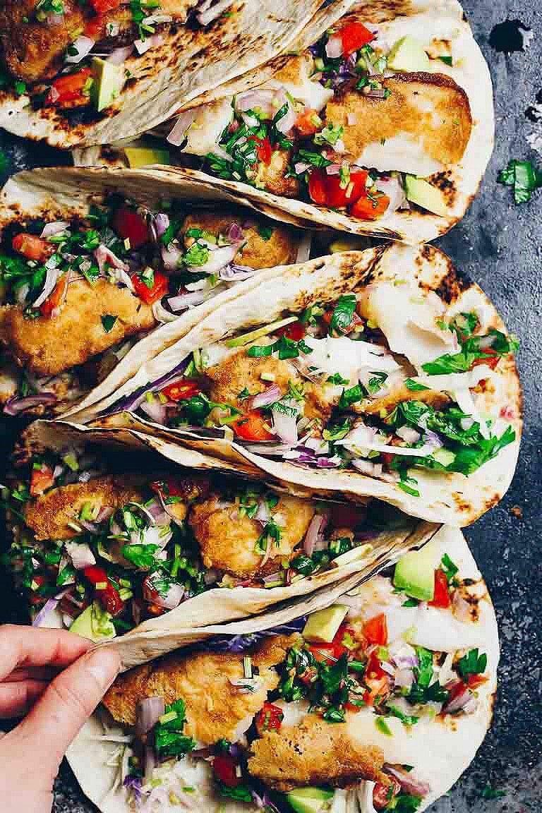 Paleo fish tacos recipe with gluten-free tortillas and tempura fish fillets and salsa sauce.