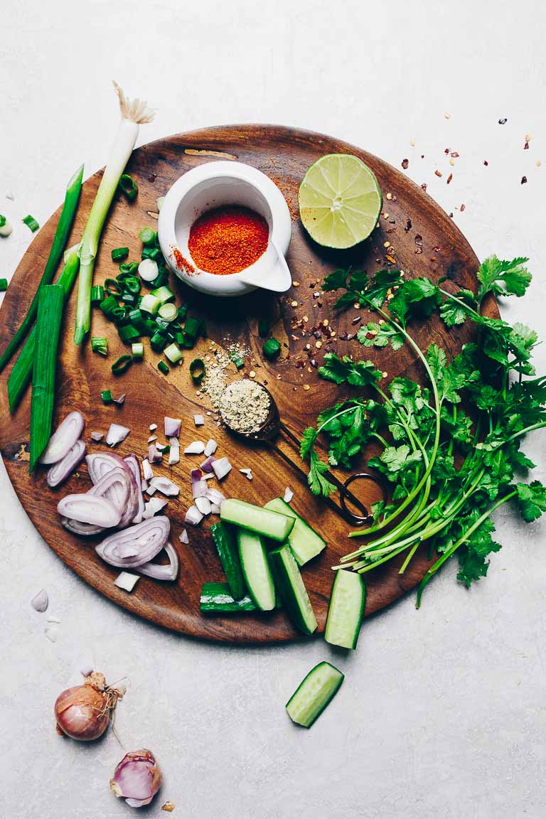 Photo shows ingredients, herbs, and seasonings used to make an authentic Thai larb with ground pork.