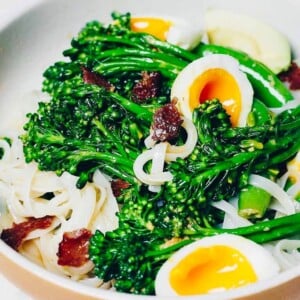 A side close shot shows a plate of noodles with broccoli tossed in a creamy ginger dressing to make a salad bowl.