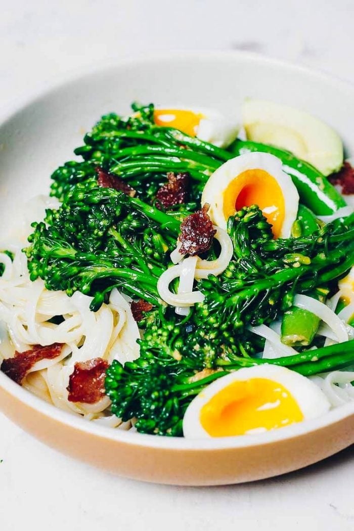 A side close shot shows a plate of noodles with broccoli tossed in a creamy ginger dressing to make a salad bowl.