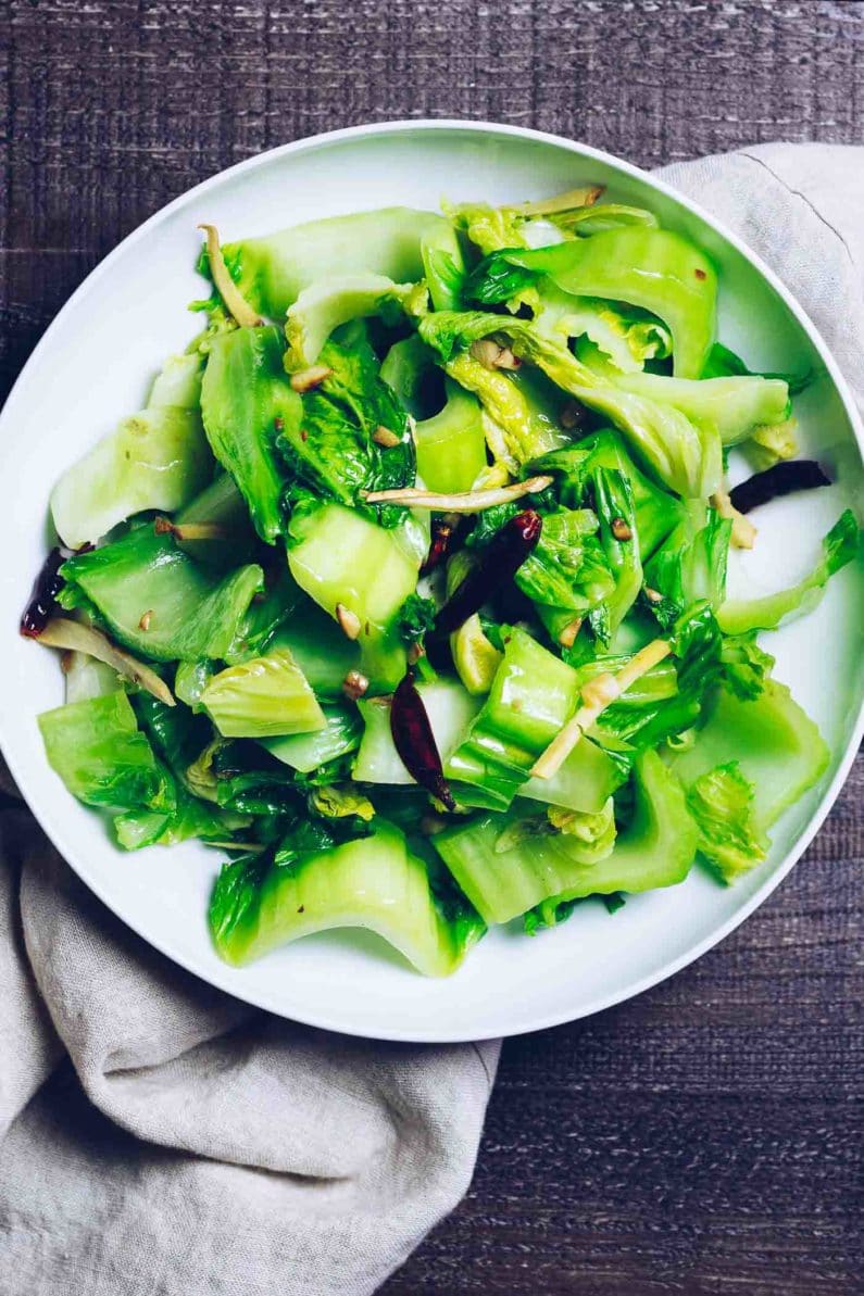 Photo shows a big white plate with Chinese mustard greens diced and sauteed on the plate
