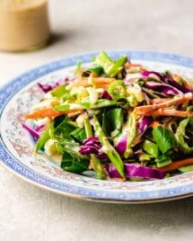Paleo Asian Coleslaw recipe, tossed in a creamy Whole30 sesame dressing.