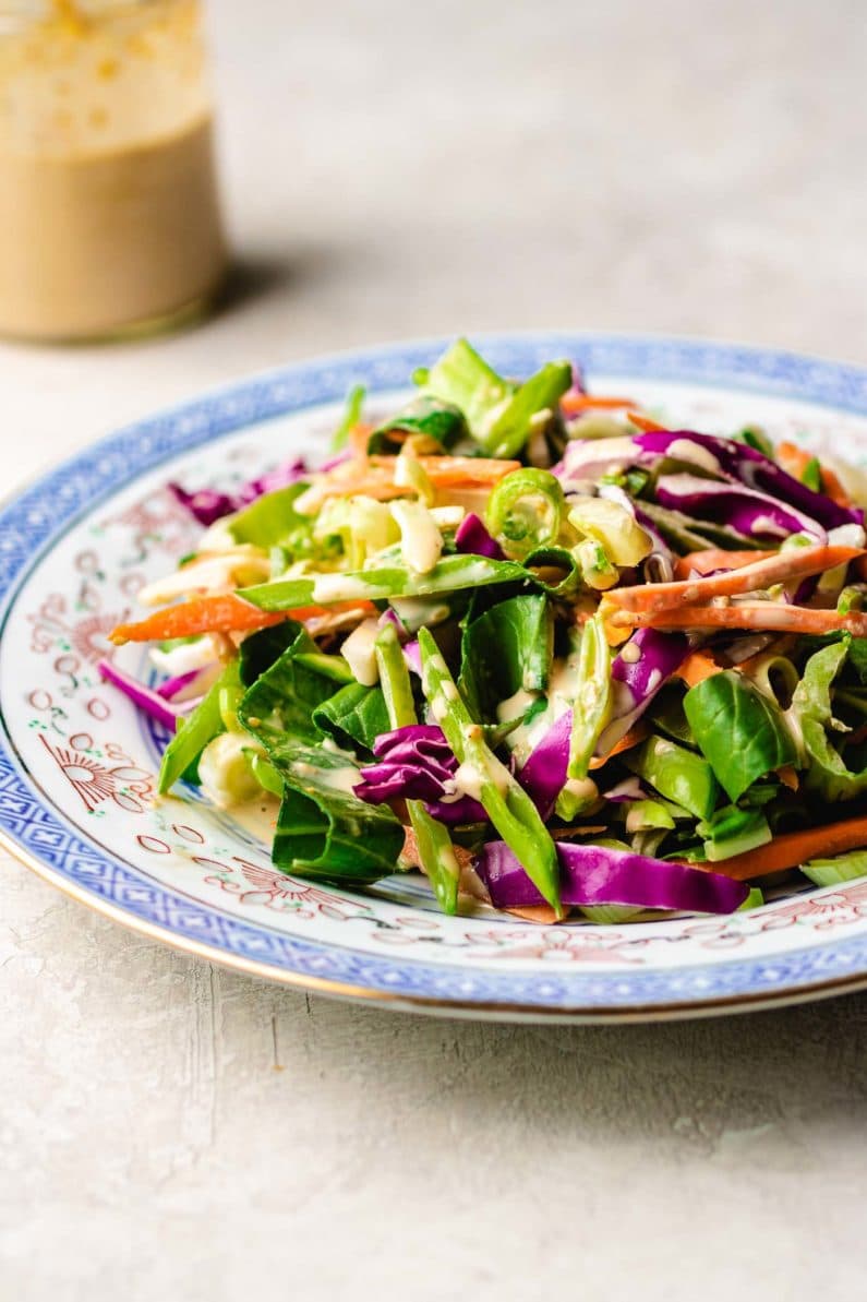 Paleo Asian Coleslaw recipe, tossed in a creamy Whole30 sesame dressing.