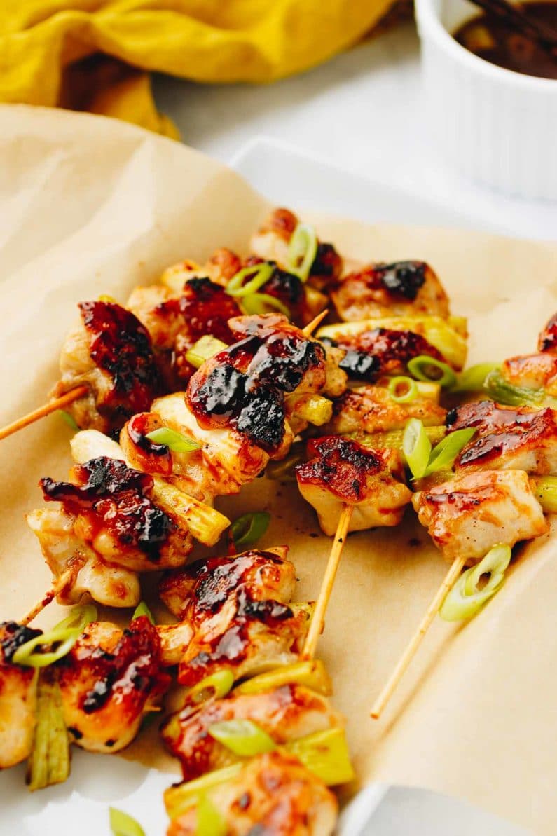 Grilled Sweet Teriyaki Chicken with scallions served on bamboo sticks
