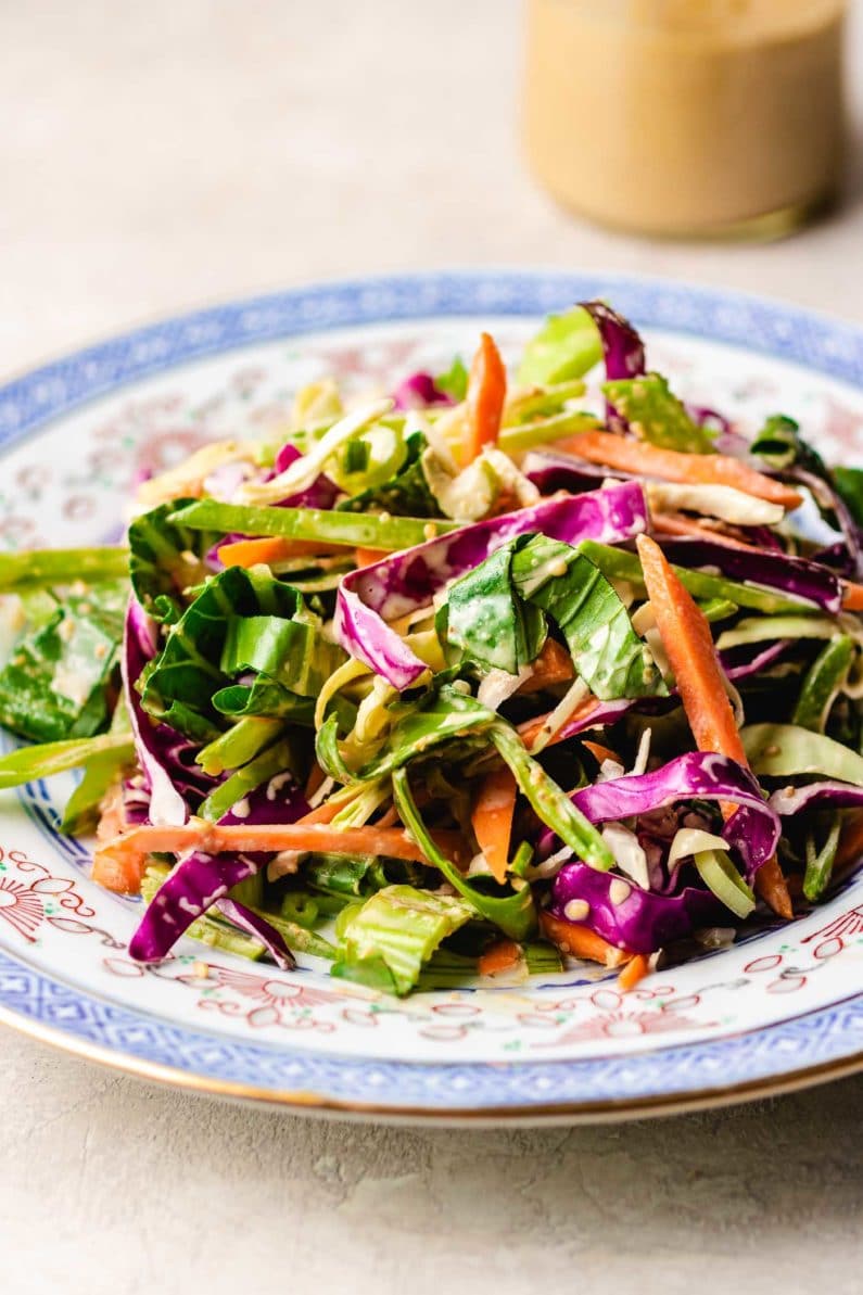 Paleo Asian Coleslaw recipe, tossed in a creamy Whole30 sesame dressing.