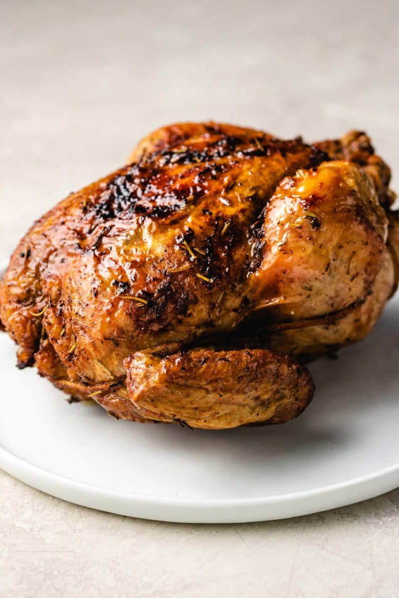 Whole chicken air fried with garlic and herbs served over a large plate