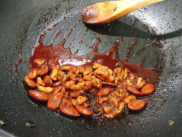Add walnuts and almonds to the sauce