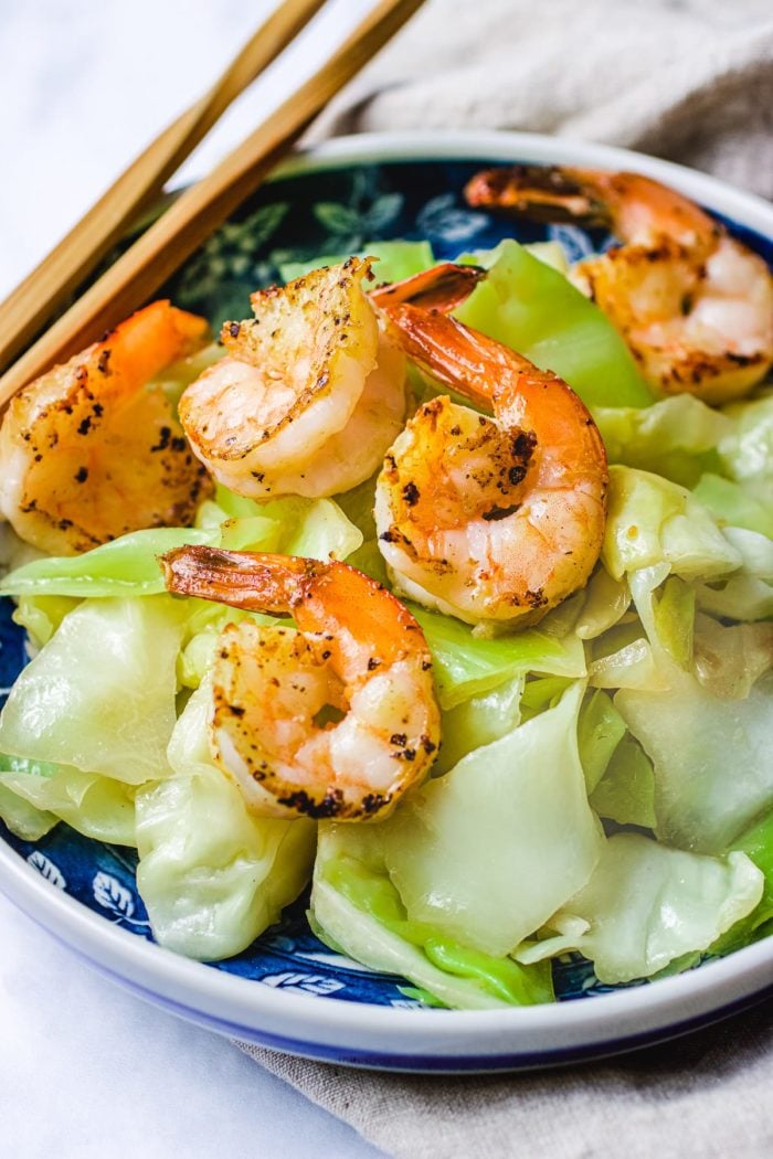Feature photo shows Taiwanese cabbage stir fried to tender and crisp. Served with seared shrimp on top as an optional topping. 