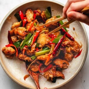 Recipe image shows a plate of Mongolian chicken with crispy chicken slices and loads of garlic, ginger and chili peppers.