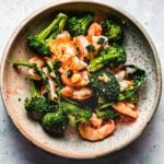 Recipe image shows shrimp and broccoli stir fried in garlic sauce and served on a plate.