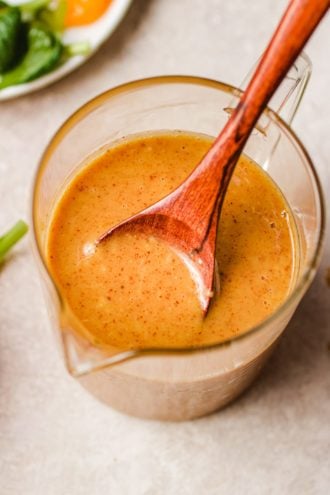 Asian peanut sauce salad dressing in a glass container