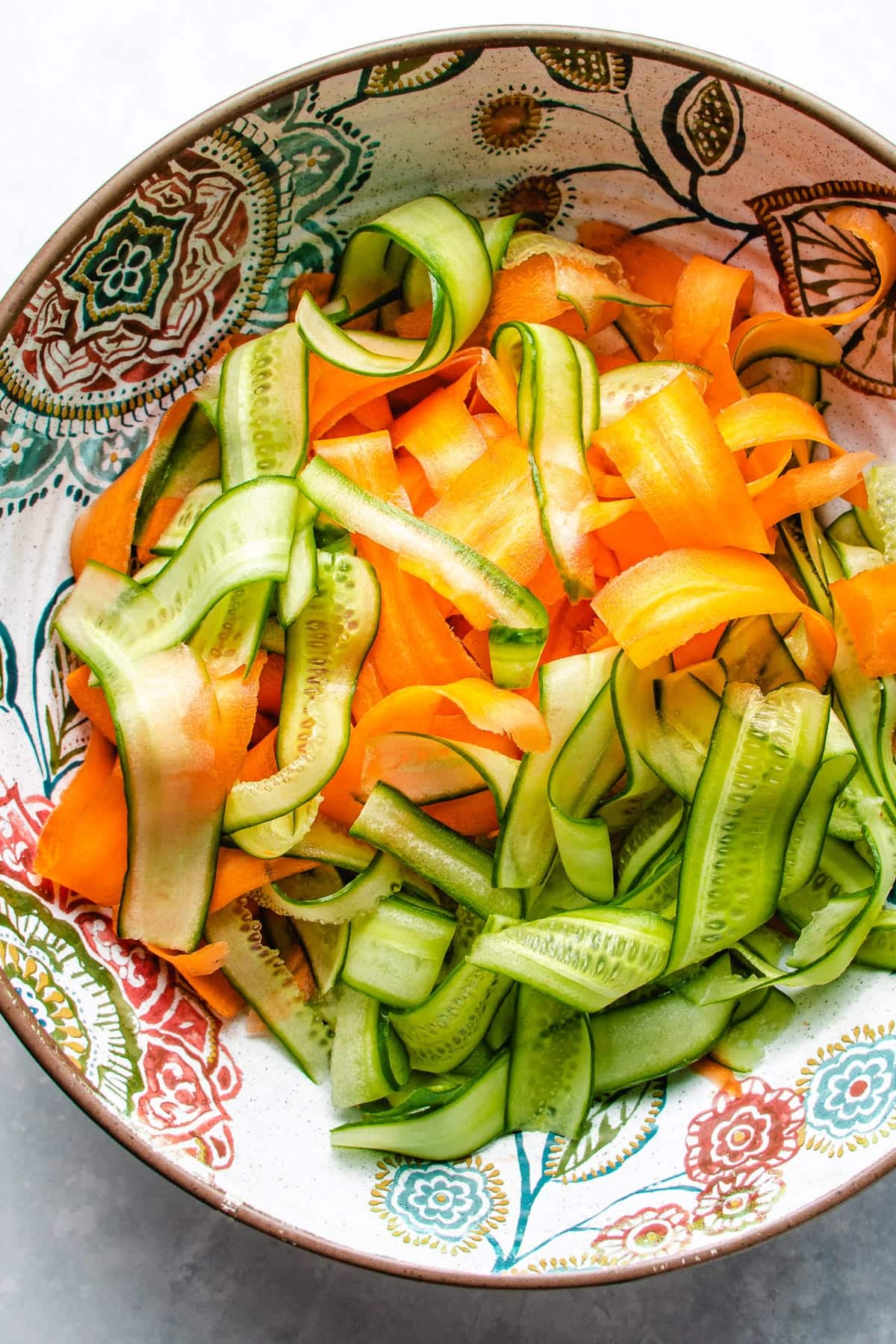 Photo shows shaved carrot and zucchini ribbon noodles to add to tatsoi or taku choy salad.